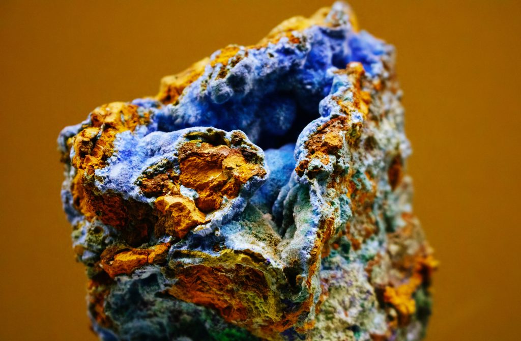 Close-up of vibrant blue and orange mineral showcasing natural texture and color contrasts.